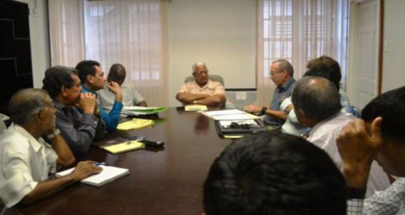 Minister of Agriculture, Noel Holder (seated at centre) meeting with members of the Guyana Rice Millers and Exporters Marketing Association