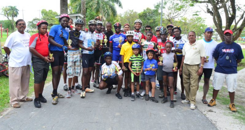 Winners in the various categories of the National Sports Commission’s 11-race cycle programme strike a pose for photographer Adrian Narine after receiving their prizes yesterday.