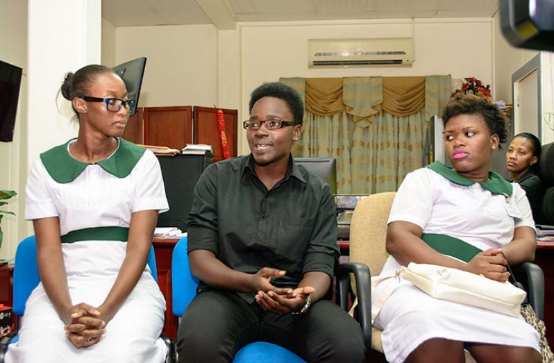 Aleea Caesar (centre) a student-nurse of the St Joseph Mercy Hospital speaks during a meeting with Minister of Public Health Dr. George Norton as other student-nurses look on. (Samuel Maughn photo)