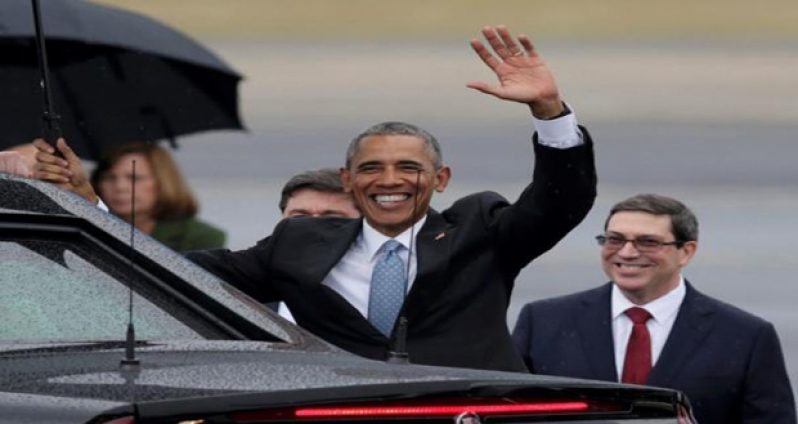 US President Barack Obama waves while standing in front of Cuba's Foreign Minister Bruno Rodriguez (right) after he arrived at Havana's international airport for a three-day trip March 20, 2016 (Reuters)
