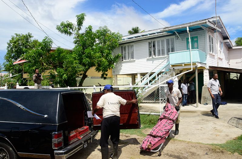 Undertakers removing the body of Allan Bhagwandin from his home