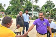 Regional Vice-Chairman, Humace Oodit, greets a resident of Golden Fleece during the walkabout