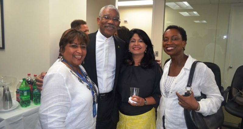 President David Granger strikes a pose with these smiling ladies who attended the meeting for members of the Guyanese diaspora, held at the Guyana Mission in New York