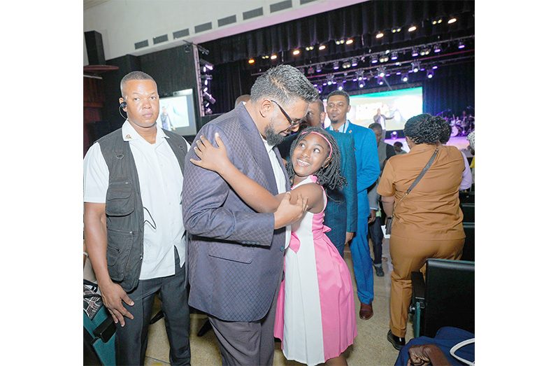 President Dr. Mohamed Irfaan Ali warmly embraces a young girl who was
among hundreds of persons at the ‘Hope is Rising’ 24-hour prayer event held at
the National Cultural Centre on Friday. Earlier in the day, President Ali received
a courtesy visit from several local pastors and their foreign counterparts who
are part of the Christian movement. During the meeting, the President emphasised that his government sees religion as a “very important” pillar for development and human advancement. He added that the government “believes
strongly” in the work of the church, and every other religious community in the
country. Discussions also focused on collaboration between the government
and the movement (OP photo)