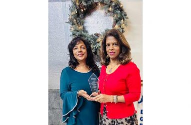Janet Naidu (right) receives the award from Shirley Najhram, President of the Pakaraima Writers Association.