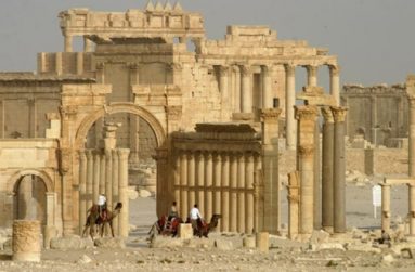 Columns and the ancient Temple of Bel are seen in the historical city of Palmyra, Syria, June 11, 2009. (REUTERS/Gustau Nacarino)