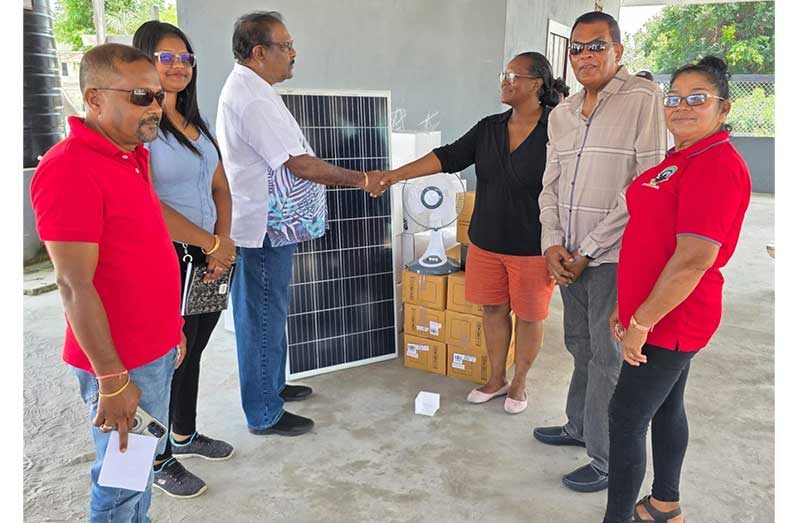 Minister within the Ministry of Local Government and Regional Development, Anand Persaud shakes the hand of a resident during the handing over ceremony. Also pictured are  Regional Vice-Chairman Humace Oodit (left) and Toshao Wendy Francis (right) and Director General of the Ministry of Agriculture Madanlall Ramraj (second right)