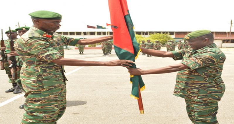 Colonel Wilbert Lee (left) officially hands over unit colours to Lieutenant Colonel Terry Benn at the parade on Thursday