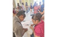 Several Region Two parents collect their CSEC fees refund