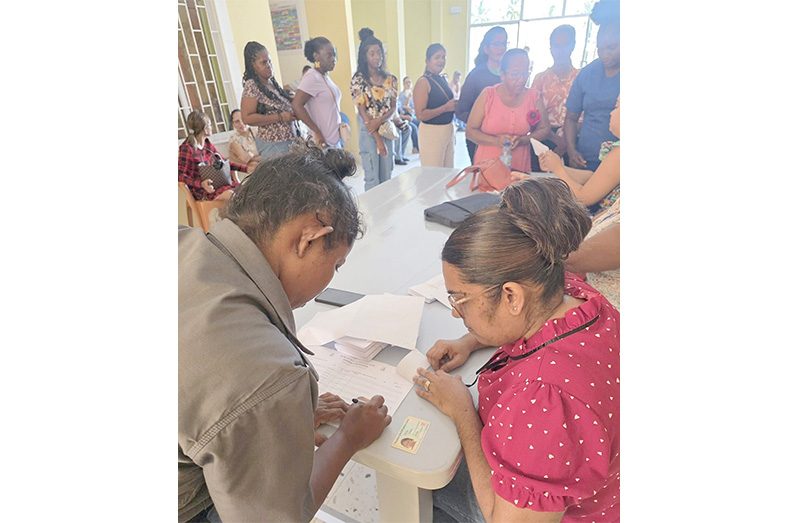 Several Region Two parents collect their CSEC fees refund