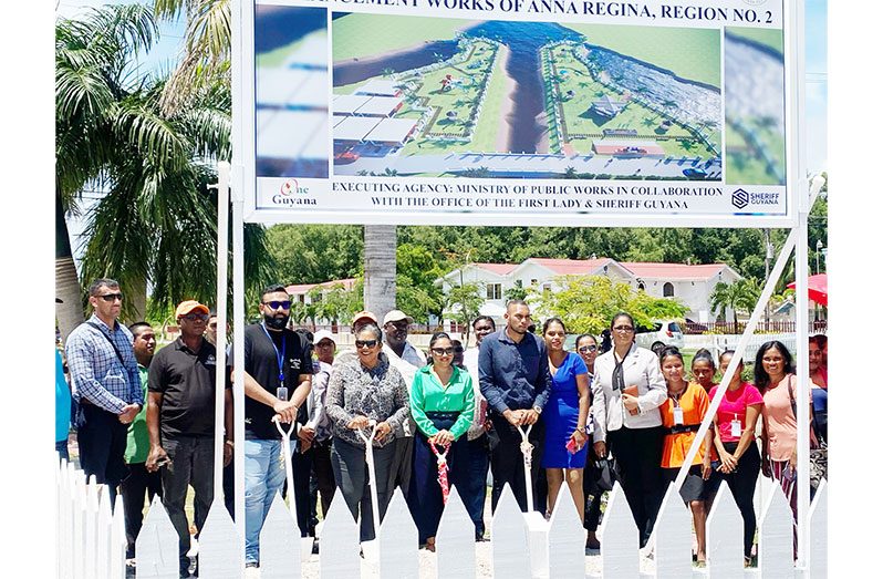 First Lady Arya Ali (centre), partners and residents at the Anna Regina Independence Park which will soon benefit from a facelift. Also pictured is a billboard with an artist’s impression of what the park is expected to look like