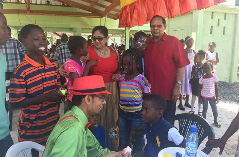 Prime Minister, Nagamootoo and his wife, Sita Nagamootoo interact with the children