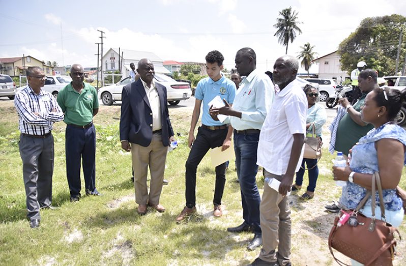 Minister of Citizenship, Mr. Winston Felix discusses the construction of the building and parking facility for the passport office, with engineers and technical officers