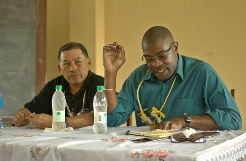 Minister of Public Infrastructure, David Patterson (right) makes a point during a meeting with residents and regional executives of Moruca, Region 1,in the presence of Minister of Indigenous Peoples’ Affairs, Sydney Allicock