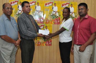 Office Manager, continental Group of Companies, Mr Ravi Brignandan hands over the cheque to Ms Nathalie Gibson in the presence of Mr Percival Boyce (left) and Khemraj Dhanraj..