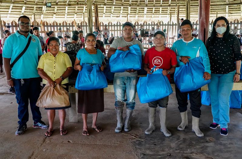 Minister Vindhya Persaud with some of the residents who received hampers