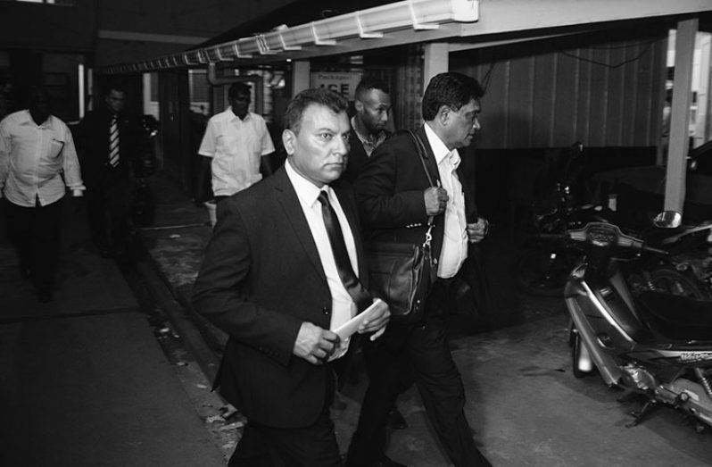 PPP, member Peter Ramsaroop escorting Charrandass Persaud out of Parliament Buildings (Keno George photo)