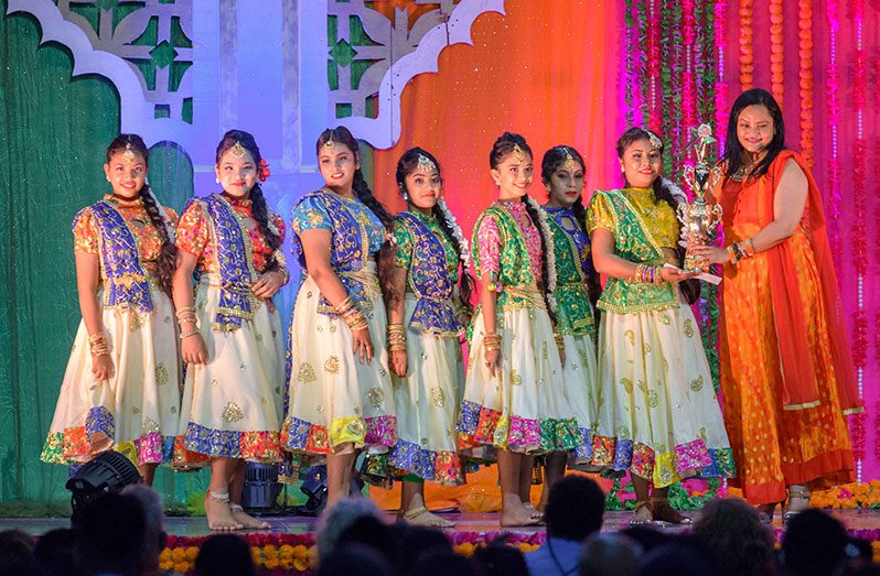 Minister of Human Services and Social Security, Dr. Vindhya Persaud, presenting the Saraswati Dance Troupe with its prize (Delano Williams photo)