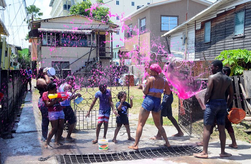 A group celebrates Phagwah on Foreshaw Street Alberttown (Adrian Narine photo)