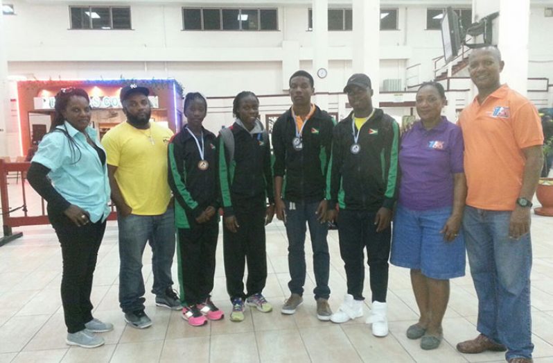 The team on their arrival at the Cheddi Jagan International airport last Tuesday morning, from left, are Team manager Mayfield Taylor-Trim, coach Johnny Gravesande, Chantoba Bright, Kenisha Phillips, Tyrell Peters, Daniel Williams, AAG Council member Yvonne October, and AAG president Aubrey Hutson.