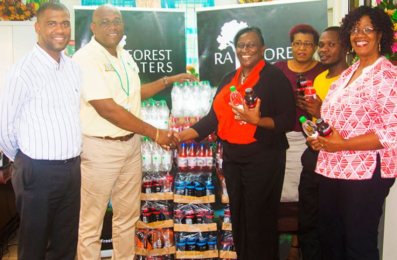 BANKS DIH Limited Brand Manager Clive Pellew makes a presentation of products to Wyles-Ogle in the presence of Lorraine Barker-King, Otis Smith and Vonne George of the Unit of Allied Arts and Errol Nelson of Banks.