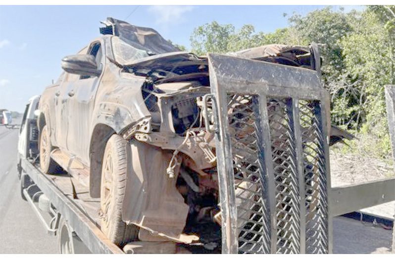 The mangled pickup being removed from the accident scene