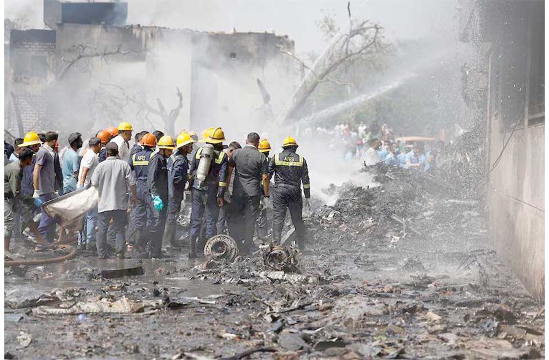 Firefighters work to put out a fire at the site where an Air India Boeing 787 Dreamliner plane crashed in Ahmedabad, India, June 12. REUTERS/Amit Dave Purchase Licensing Rights