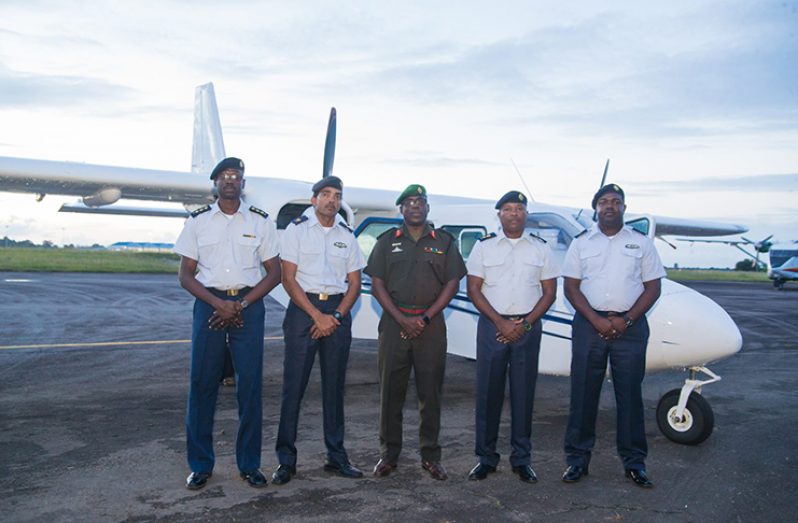 Chief of Staff of the GDF, Brigadier Patrick West [centre], Commander of the Air Corps, Lieutenant Colonel Courtney Byrne [second right] and Major Mohinder Ramjag, Officer in Command at the Flight Operations Department [second left] among other GDF officials pose in front one of the Islanders