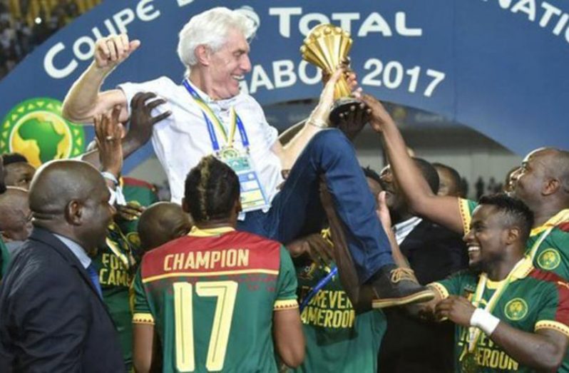 Cameroon boss Hugo Broos is lifted aloft by his players.