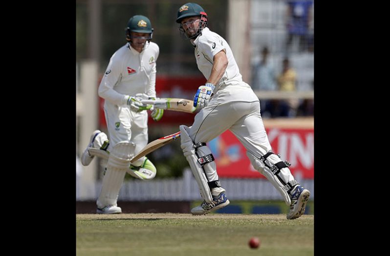 Shaun Marsh and Peter Handscomb run between the wickets in their 124-run stand.