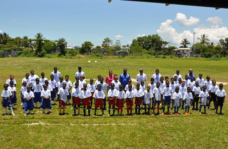 Players, coaches and office ials showing off their tournament jerseys on Friday at the Grove ground before the kick-off.