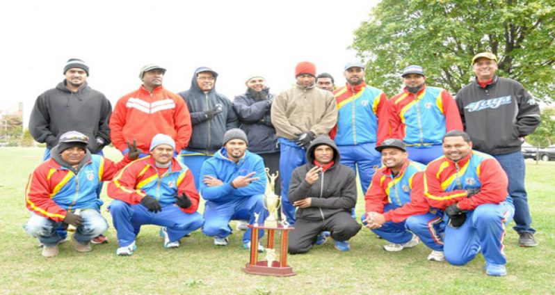 The victorious Dant players and OSCL executives pose following the team’s victory. OSCL president Albert Ramcharran is at far right (standing).