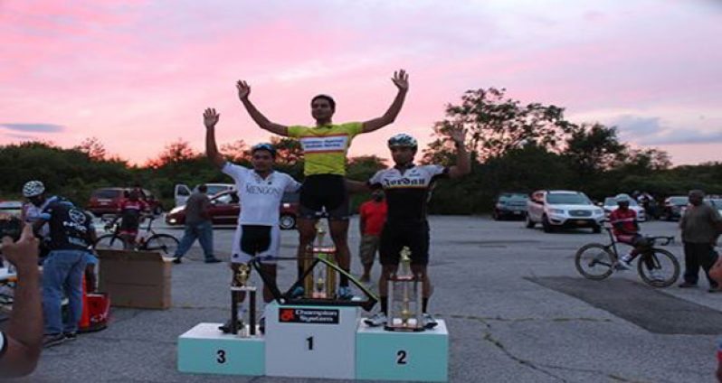 Scott Savory stands at the top of the podium displaying his silverware.
