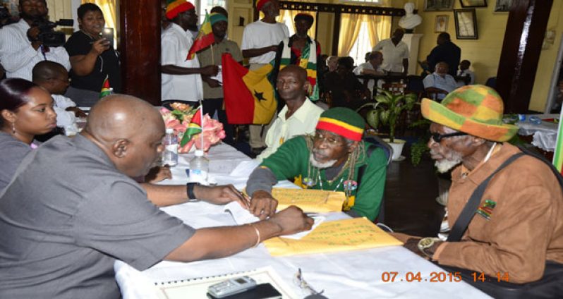 Theocracy Party Leader Alfred Parks and party General Secretary Ras Leon Saul offering an explanation to GECOM’s Chief Elections Officer Keith Lowenfield