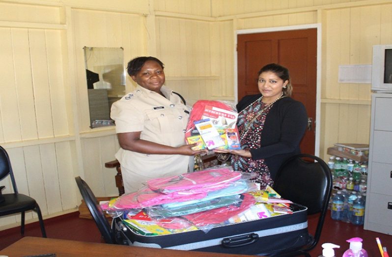 Woman Assistant Superintendent, J.Sullivan receiving the supplies from SDC Secretary L. Narine