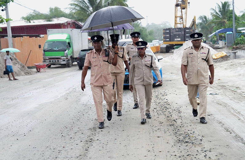 Police Commissioner Clifton Hicken (centre) and Traffic Chief Assistant Commissioner Mahendra Singh (right) on Thursday engaged contractors responsible for road expansion works along the East Bank Demerara corridor. The ongoing works have been contributing to heavy traffic congestion during peak hours (GPF photos)