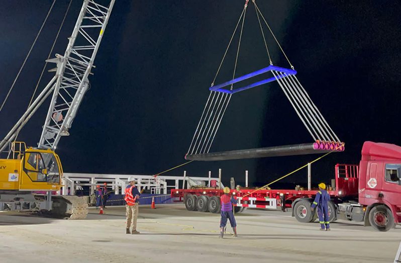 Offloading of onshore pipeline segments at the Nismes laydown yard of GAICO Construction and General Services Inc. on the West Bank Demerara