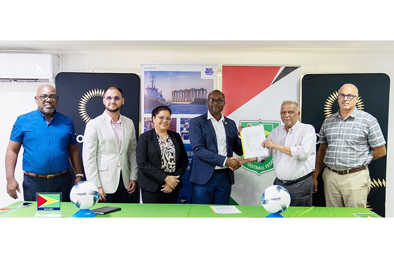 From left: Rawlston Adams (Second Vice-President -Guyana Football Federation), Richard DeNobrega (Senior Vice-President of Sales & Development - Blue Water Shipping), Jenifer Falconer (Senior Vice-President of Operations – Blue Water Shipping), Wayne Forde (President – Guyana Football Federation), Ravi Narine (SRKN’gineering and Associates Limited) and Tristan Gomes (SRKN’gineering and Associates Limited) after the signing of the consultancy agreement on Friday