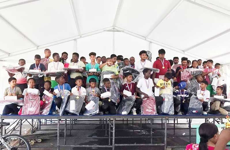 Youths poses after receiving school bags from the Basil Butcher Trust