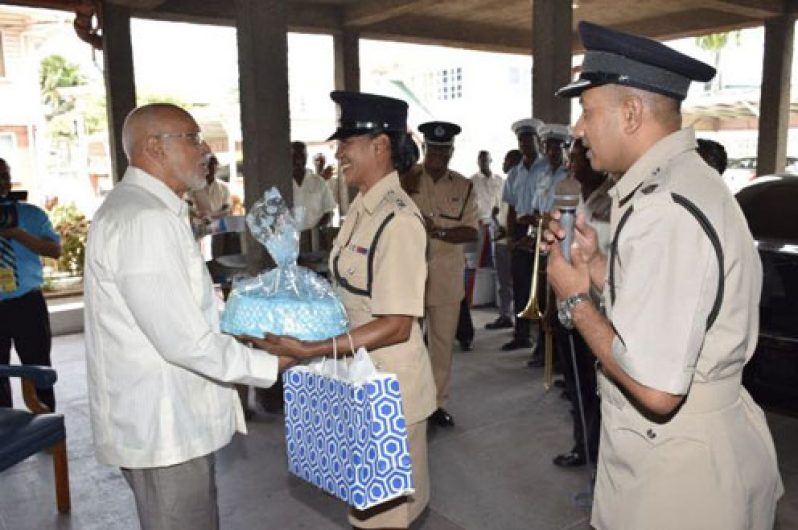 President Donald Ramotar receives a birthday present from members of the Guyana Police Force