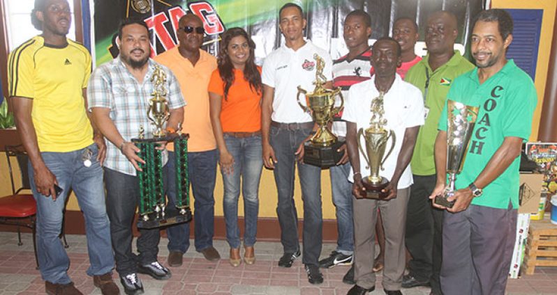 The top four EBFA clubs show off their trophies after receiving cash awards from Ansa McAl’s PRO Darshanie Yusuf (4th left) and Assistant Stag Beer Brand Manager Sean Abel (5th left). Also in photo are EBFA Secretary Franklin Wilson (3rd left) and President Wayne Francois (3rd right)