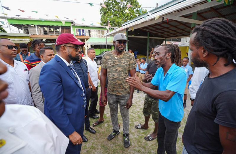 President Ali interacts with some residents during his visit to Leopold Street, Georgetown and engages youths who are part of an ongoing community employment project