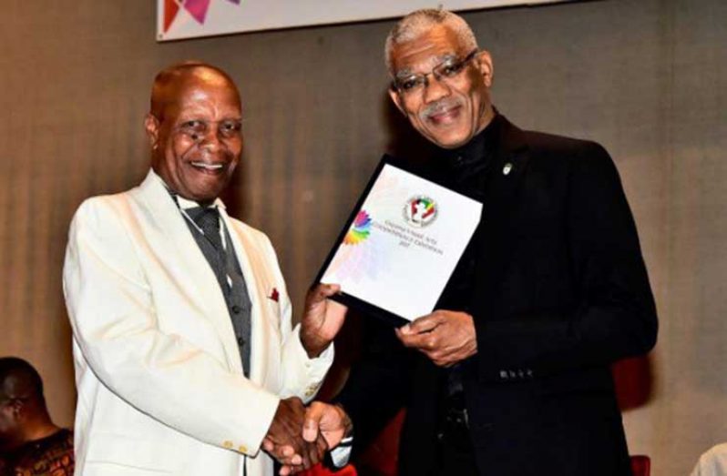 President David Granger presenting the Guyana Visual Art Competition’s Lifetime Achievement Award to Jorge Bowenforbes at the National Cultural Centre on Thursday