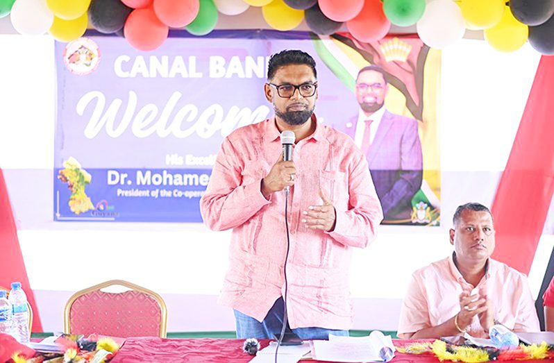 President Dr. Irfaan Ali addresses residents of Canal Bank in Region One. Also pictured is Housing Minister, Collin Croal
