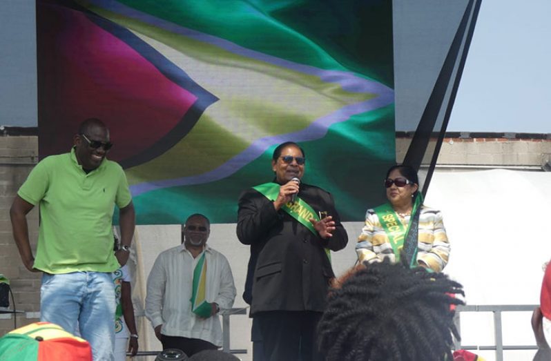 Prime Minister Moses Nagamootoo addresses the gathering as his wife, Sita, and others look on