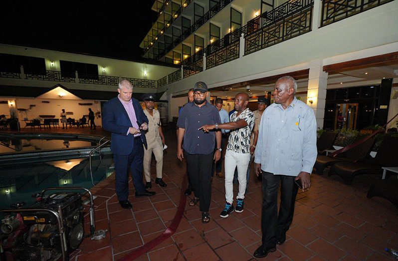 President, Dr. Irfaan Ali being briefed at the fire scene (Office of the President photo)