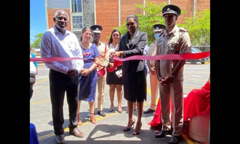 Permanent Secretary, Mae Toussaint Jr. Thomas (third from left), cuts the ribbon to officially open the exhibition. Also pictured are Minister of Home Affairs, Robeson Benn (left), Director of Prisons Nicklon Elliot (left) and other officials (Ministry of Home Affairs photo)