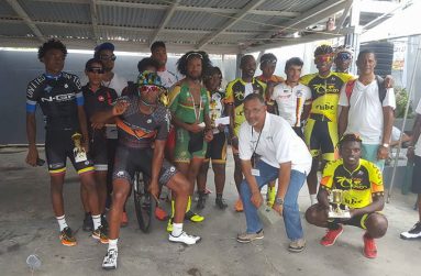 Prize winners of the Chin Chan Cycle Store’s 70-mile road race strike a pose with their trophies and monetary rewards.