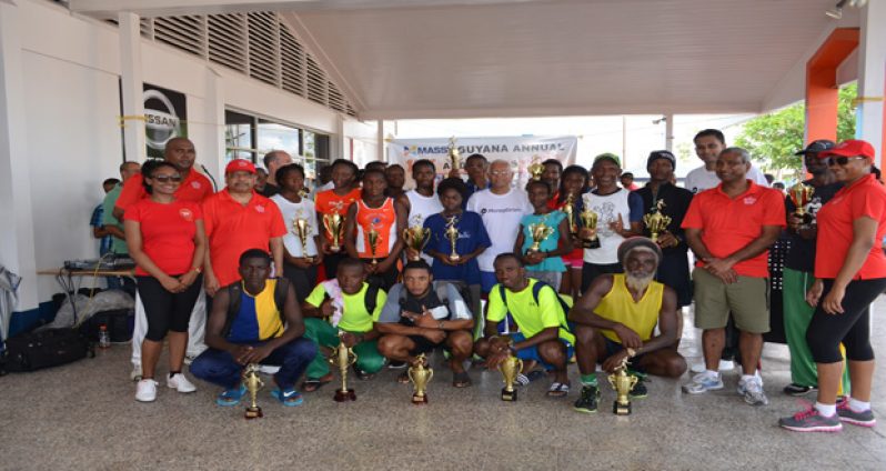 Prize winners of the various categories strike a pose with executives of the Massy Group.
Standing at centre with white T-shirt and spectacles is the Company’s Chief Executive Officer Doodnauth Persaud.