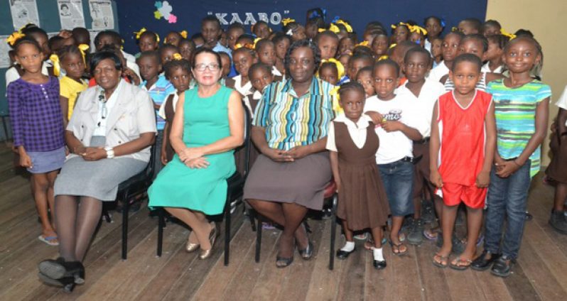 First Lady Mrs Sandra Granger (centre) and Mrs. Genevieve Allen, with some of the children of the Remedial Project